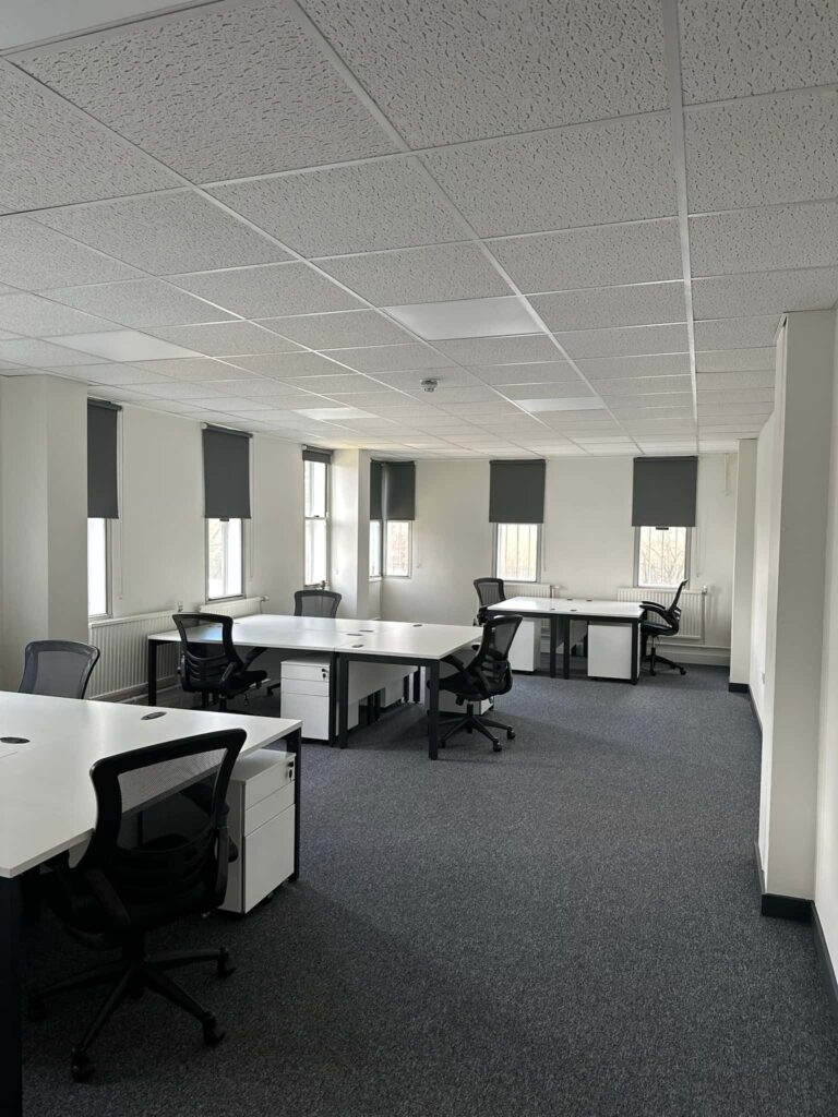 multiple desks in monochrome office space