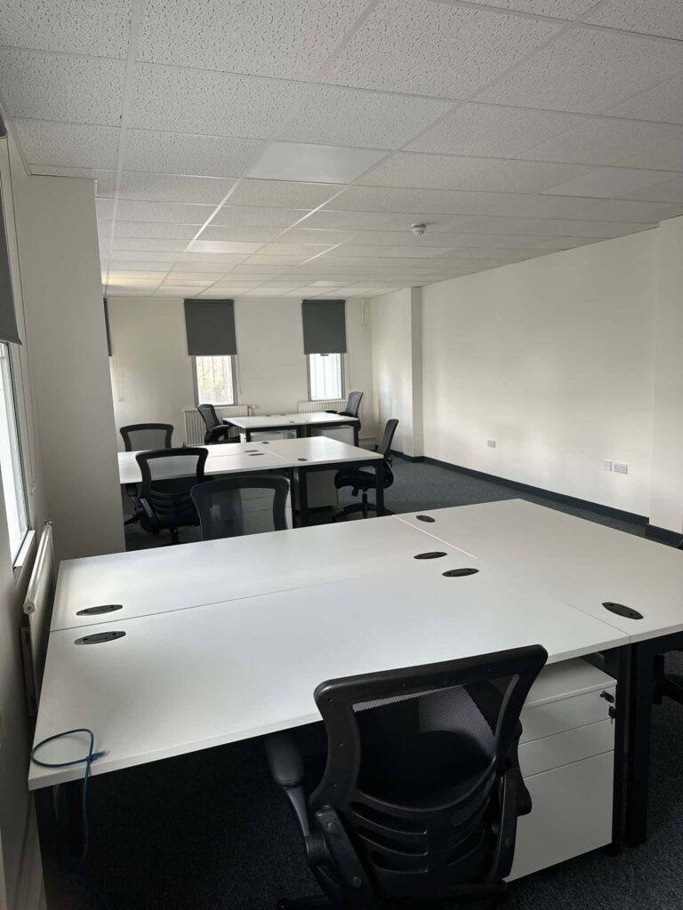 multiple desks in monochrome office space